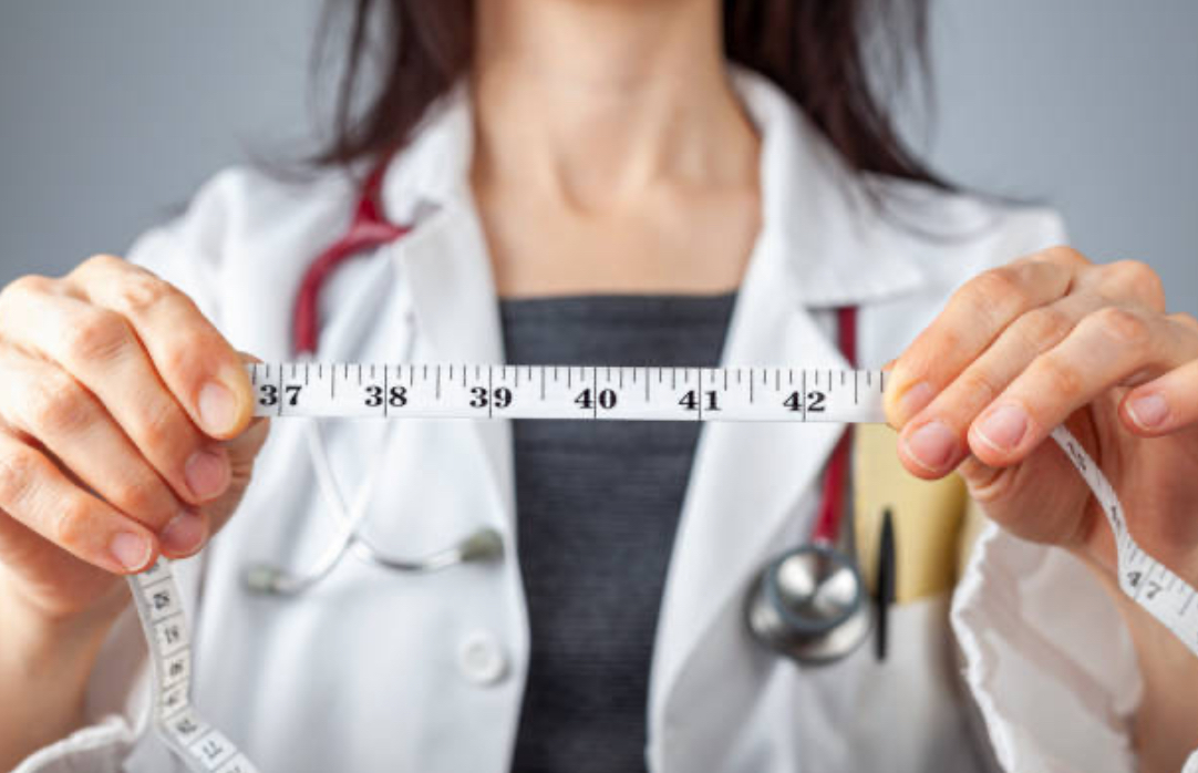 Weight Loss- Doctor with Measuring tape.